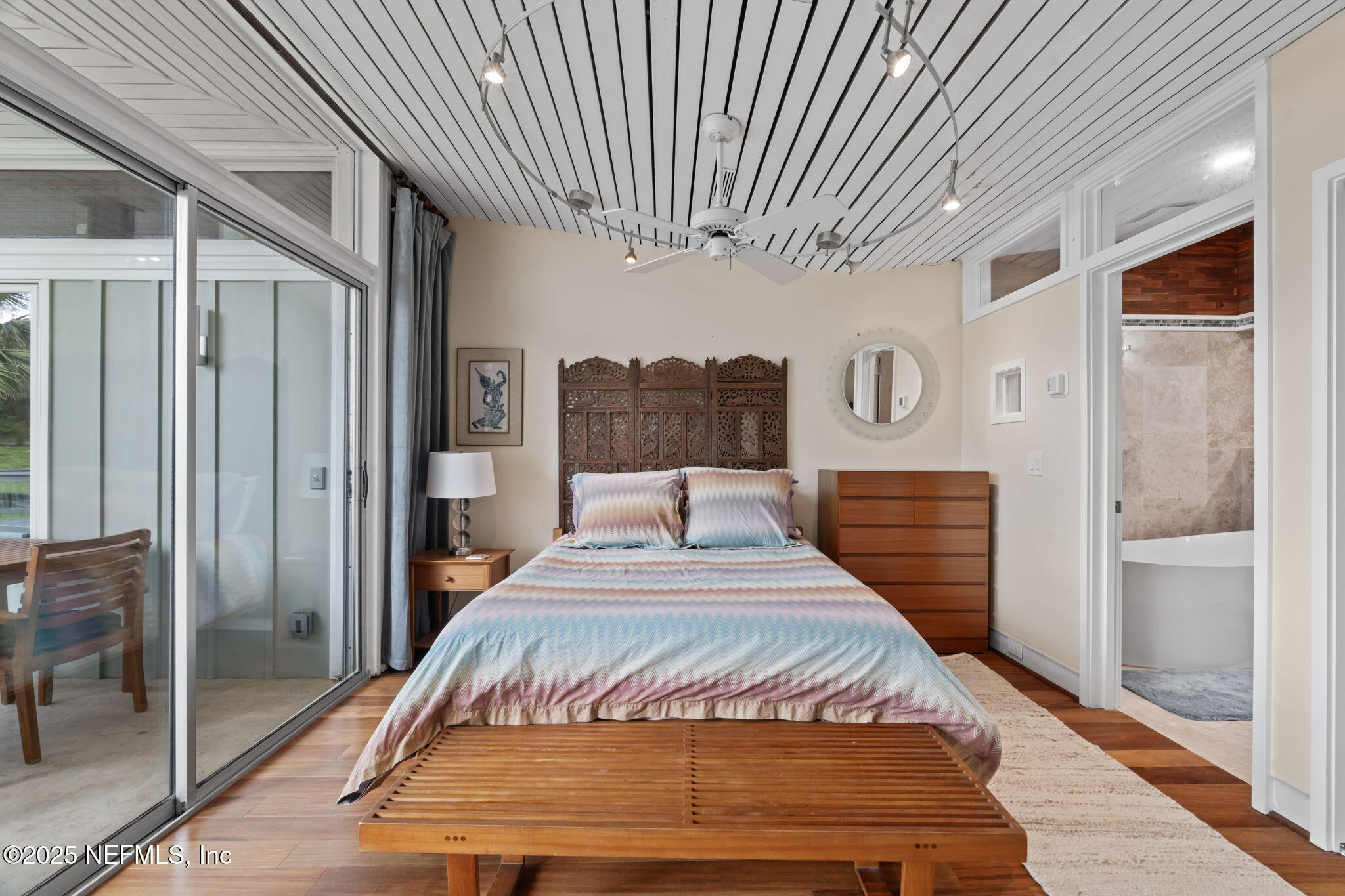 2337 Seminole Road, Unit B Atlantic Beach, FL 32233 - Photo 9 of 19 a bedroom with a large bed and a chandelier