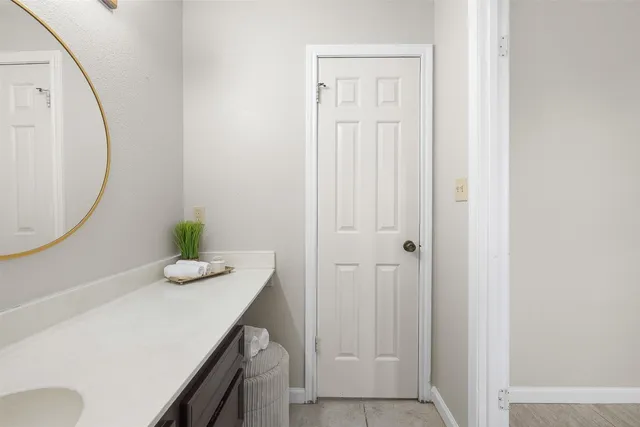 a room with a sink and a mirror