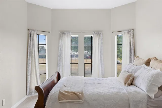 a bedroom with a bed and a window