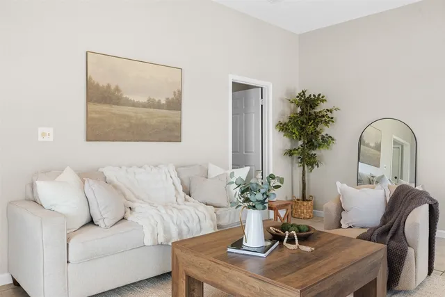 a living room with furniture and flowers