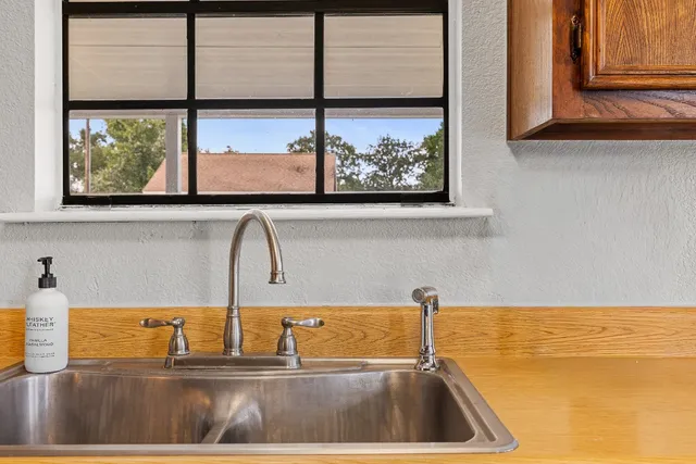 a kitchen with a sink and a window
