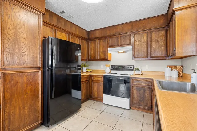 a kitchen with granite countertop stainless steel appliances and wooden cabinets