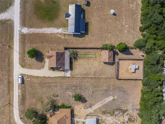 an aerial view of a house with a yard and potted plants