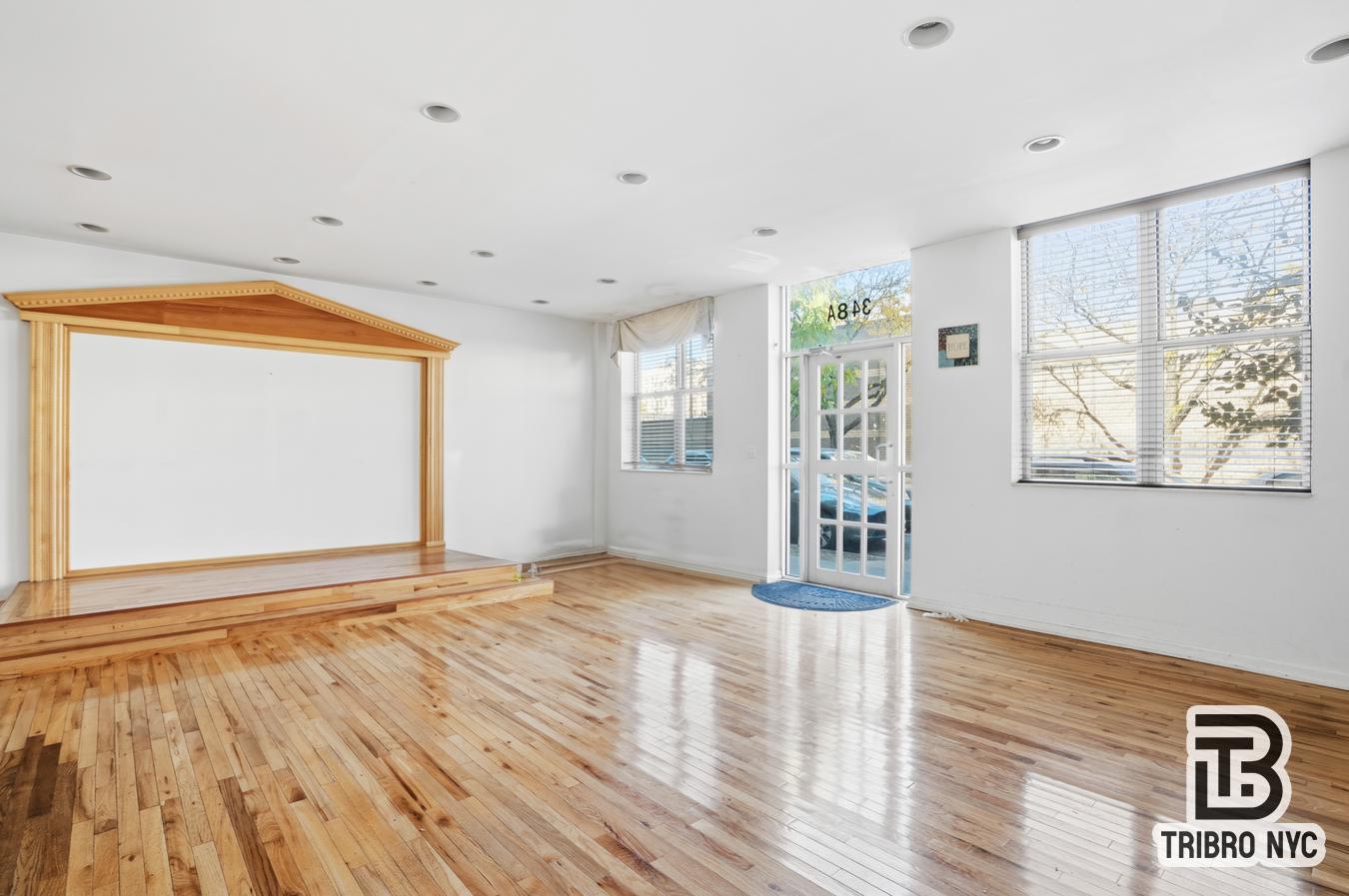 348 East 110th Street, Unit RETAIL Manhattan, NY 10029 - Photo 2 of 11 a view of an empty room with wooden floor and a window