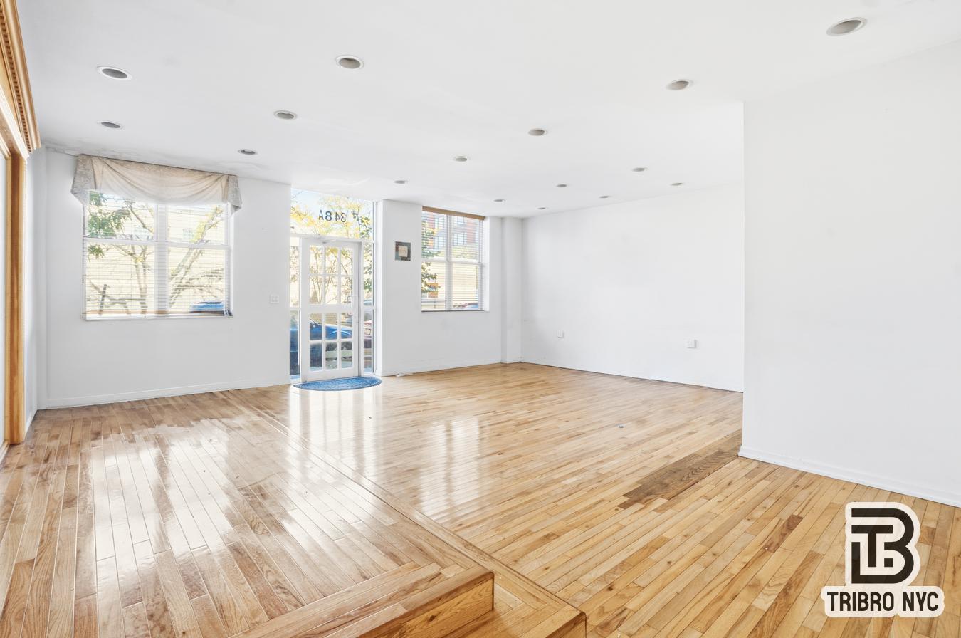 348 East 110th Street, Unit RETAIL Manhattan, NY 10029 - Photo 7 of 11 a view of an empty room with wooden floor and a window