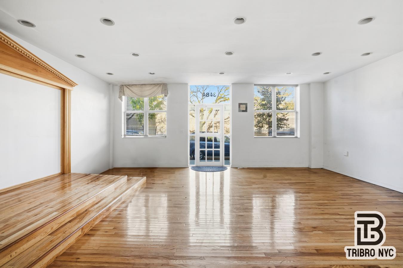 348 East 110th Street, Unit RETAIL Manhattan, NY 10029 - Photo 8 of 11 a view of an empty room with a window and wooden floor