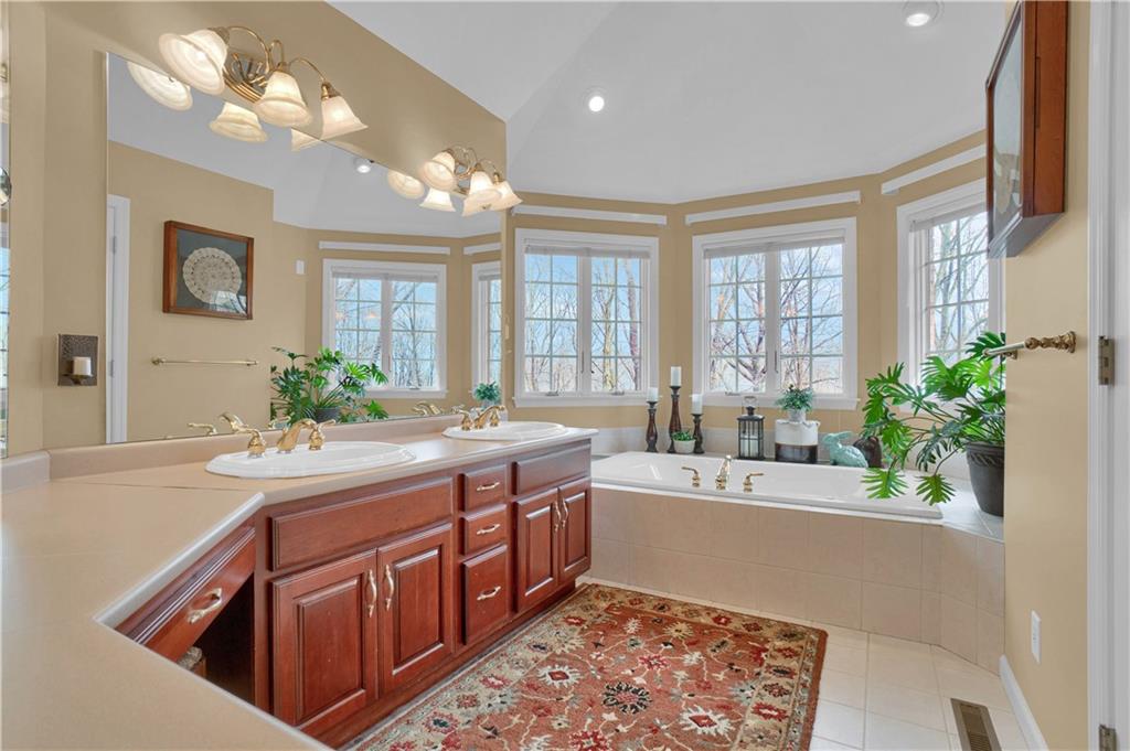 115 Cedar Ridge Butler, PA 16001 - Photo 13 of 25 a spacious bathroom with a sink a large mirror and a shower