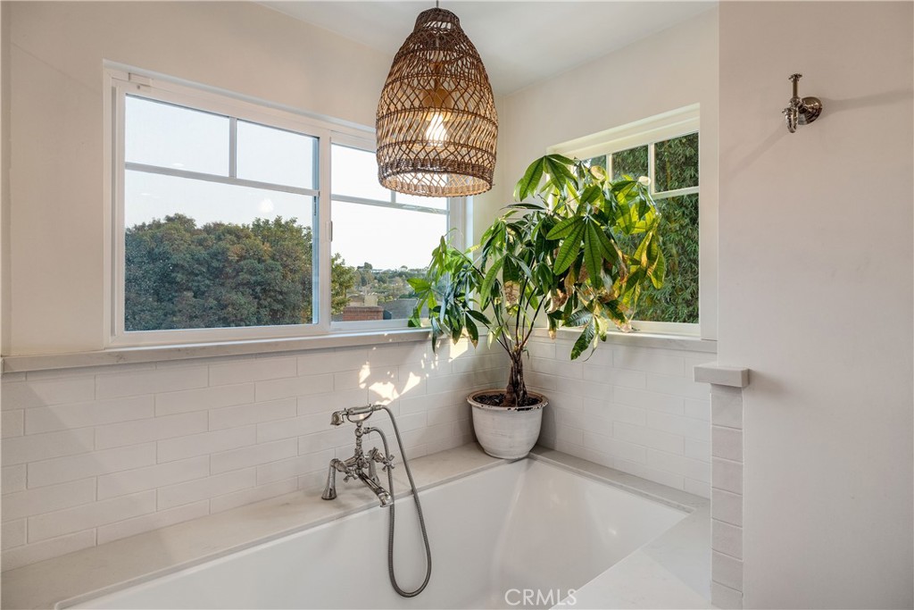 1006 Ave H Redondo Beach, CA 90277 - Photo 57 of 75 a white bath tub sitting in a bathroom next to a window