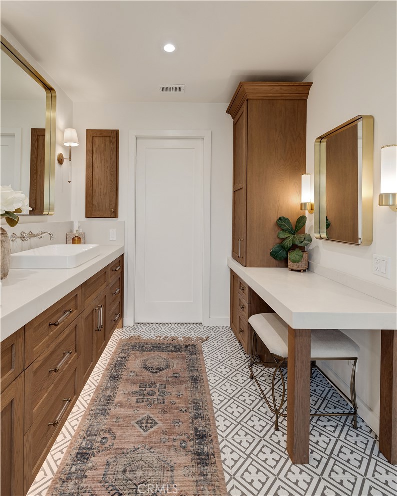 1006 Ave H Redondo Beach, CA 90277 - Photo 61 of 75 a spacious bathroom with a double vanity sink and a mirror