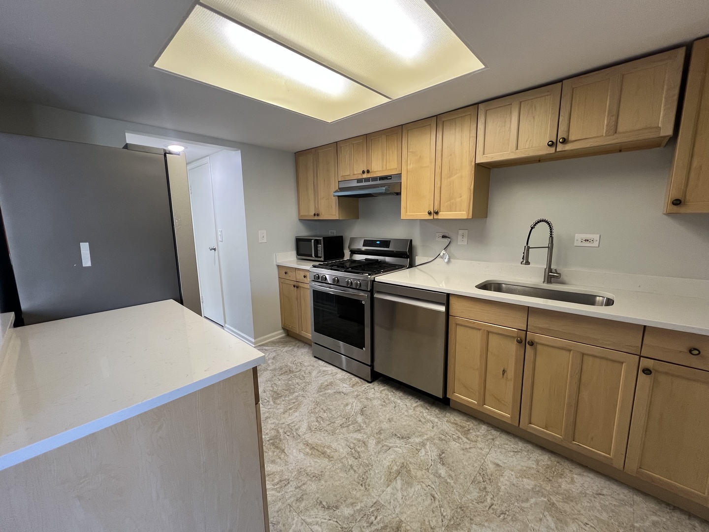 936 Cardiff Court Schaumburg, IL 60169 - Photo 2 of 11 a kitchen with stainless steel appliances granite countertop a sink stove and refrigerator