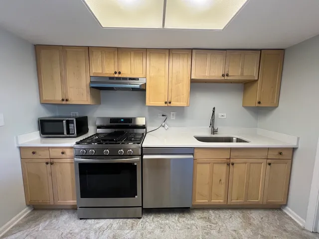 a kitchen with a stove and cabinets
