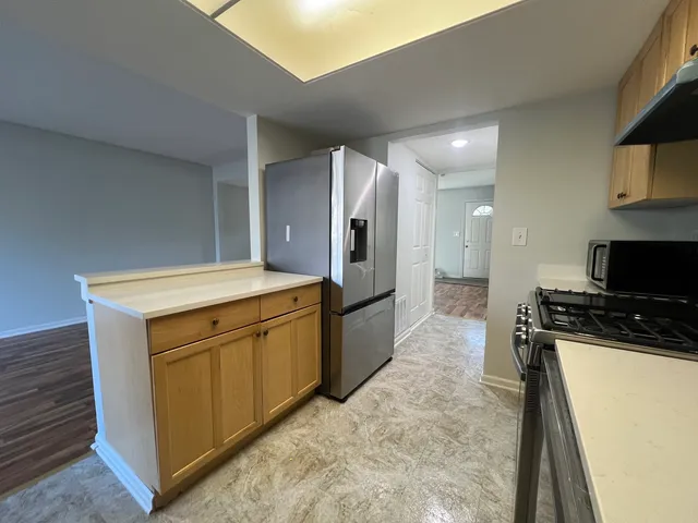a kitchen with a sink and a refrigerator