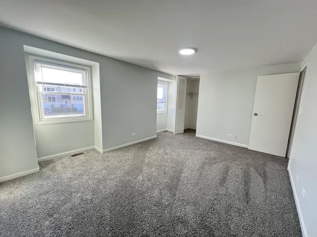 a view of an empty room and a window