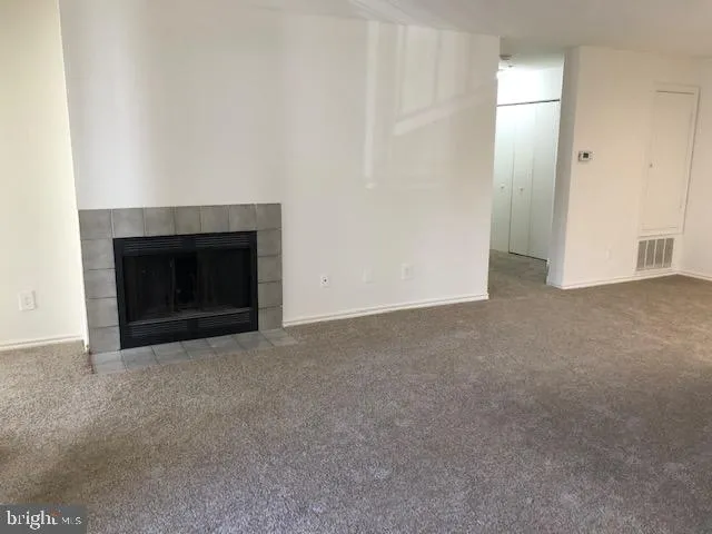 a view of empty room with a fireplace
