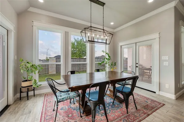 a dining room with furniture window and wooden floor