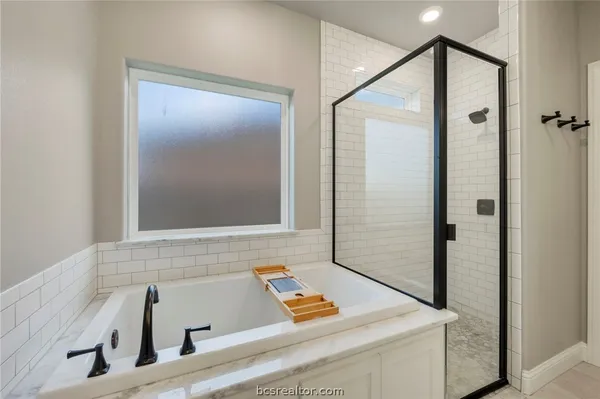 a bathroom with a tub and shower