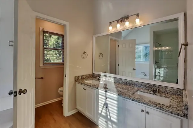 a bathroom with a granite countertop sink mirror and double