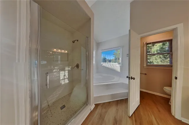 a bathroom with a glass shower door and a bathtub