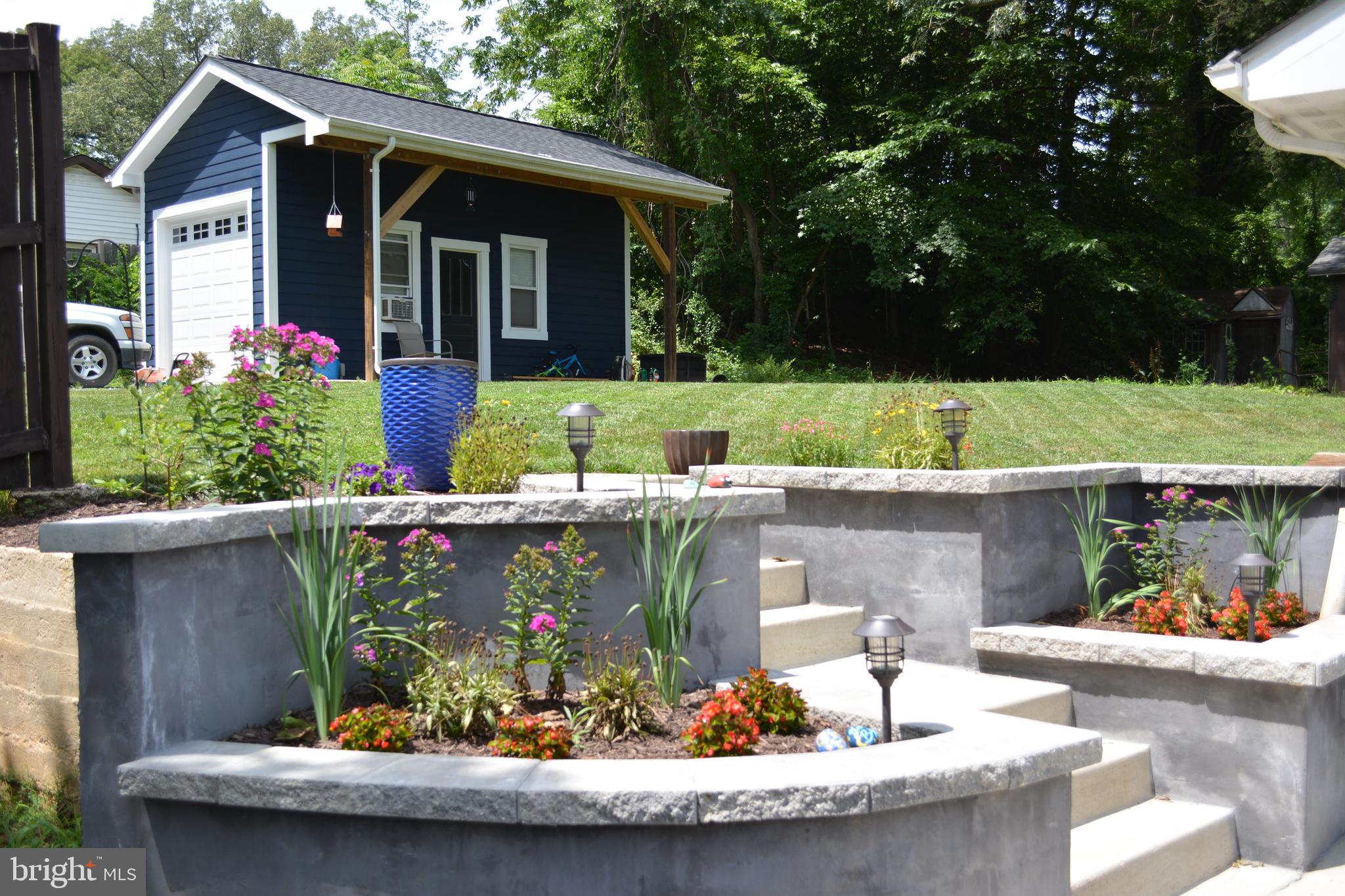 18618 Old Triangle Road Triangle, VA 22172 - Photo 28 of 34 Steps up to a large, flat backyard and garage/shop