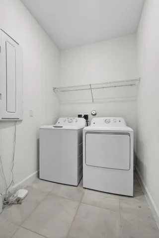 an empty room with chandelier fan