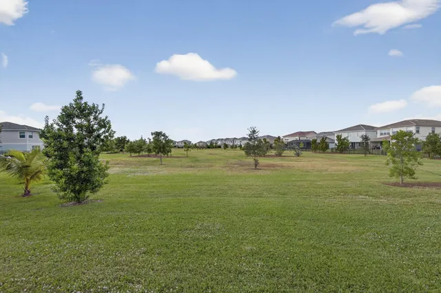 a view of a patio with table and chairs and floor to ceiling window with wooden floor