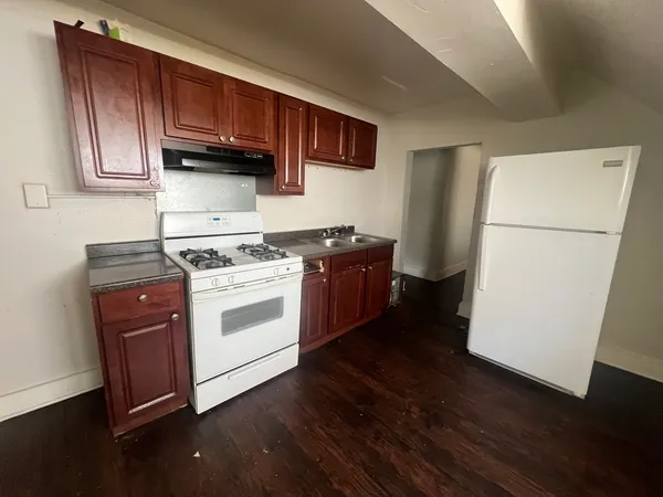 a kitchen with a stove a microwave and a refrigerator