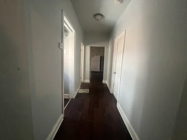 a view of a hallway with a wooden floor