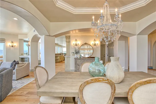 a large kitchen with kitchen island a large counter space a chandelier and living room view