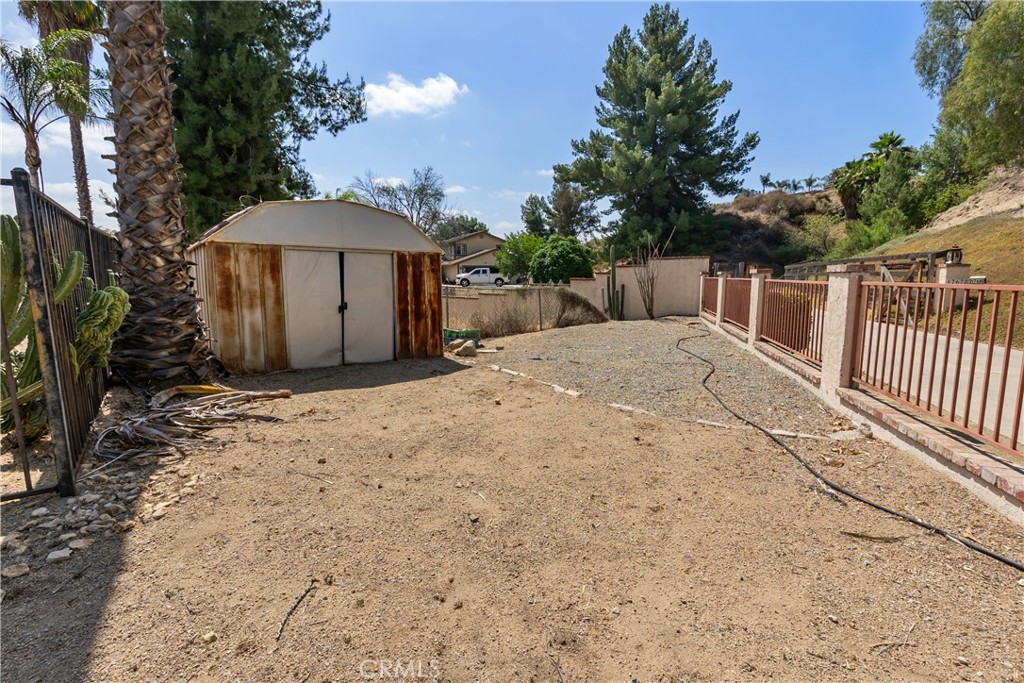 17656 Mockingbird Hill Circle Riverside, CA 92504 - Photo 36 of 49 a view of a backyard with a barbeque and fence