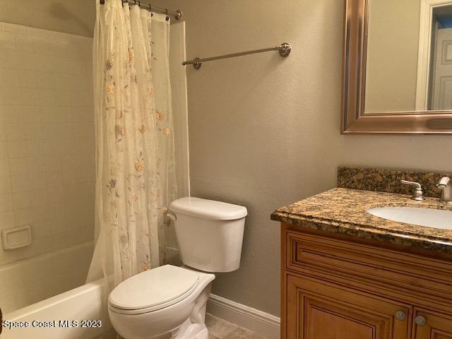 7667 North Wickham Road, Unit 502 Melbourne, FL 32940 - Photo 2 of 19 a bathroom with a granite countertop toilet sink and a shower