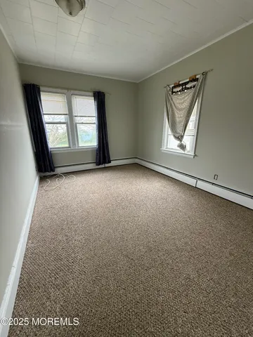 an empty room with windows and closet