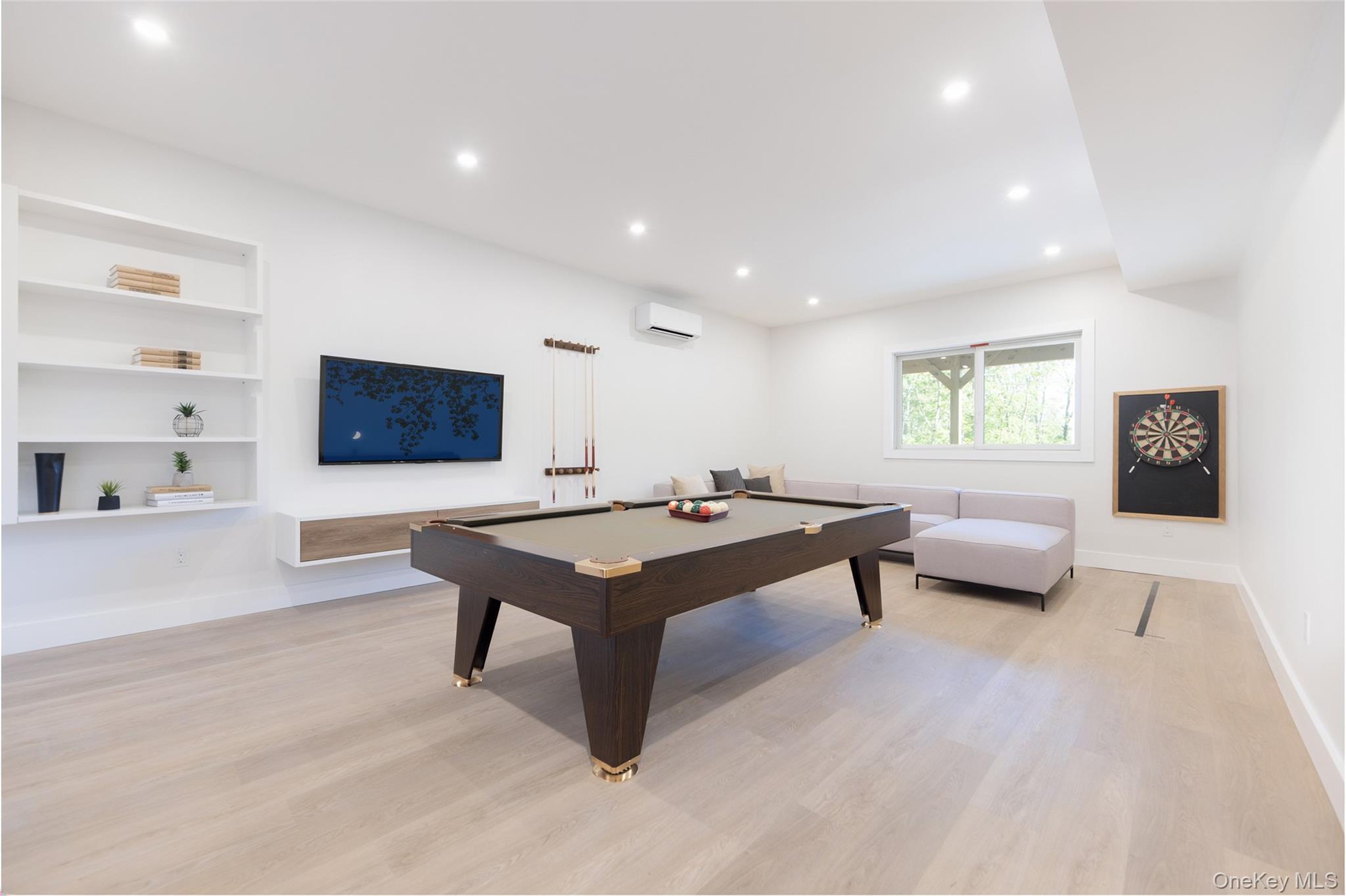 91 Lenni Lenape Road Narrowsburg, NY 12764 - Photo 17 of 25 Spacious recreation area featuring light wood-finish flooring, recessed lighting, and built-in shelvingImages have been virtually staged to illustrate the property's potential