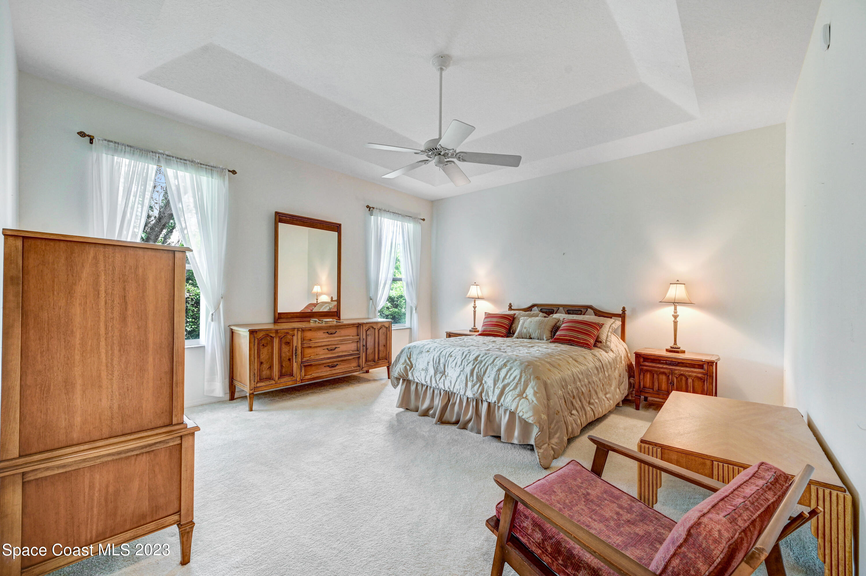 368 Renaissance Avenue Melbourne, FL 32940 - Photo 15 of 29 a bedroom with a bed and a chandelier