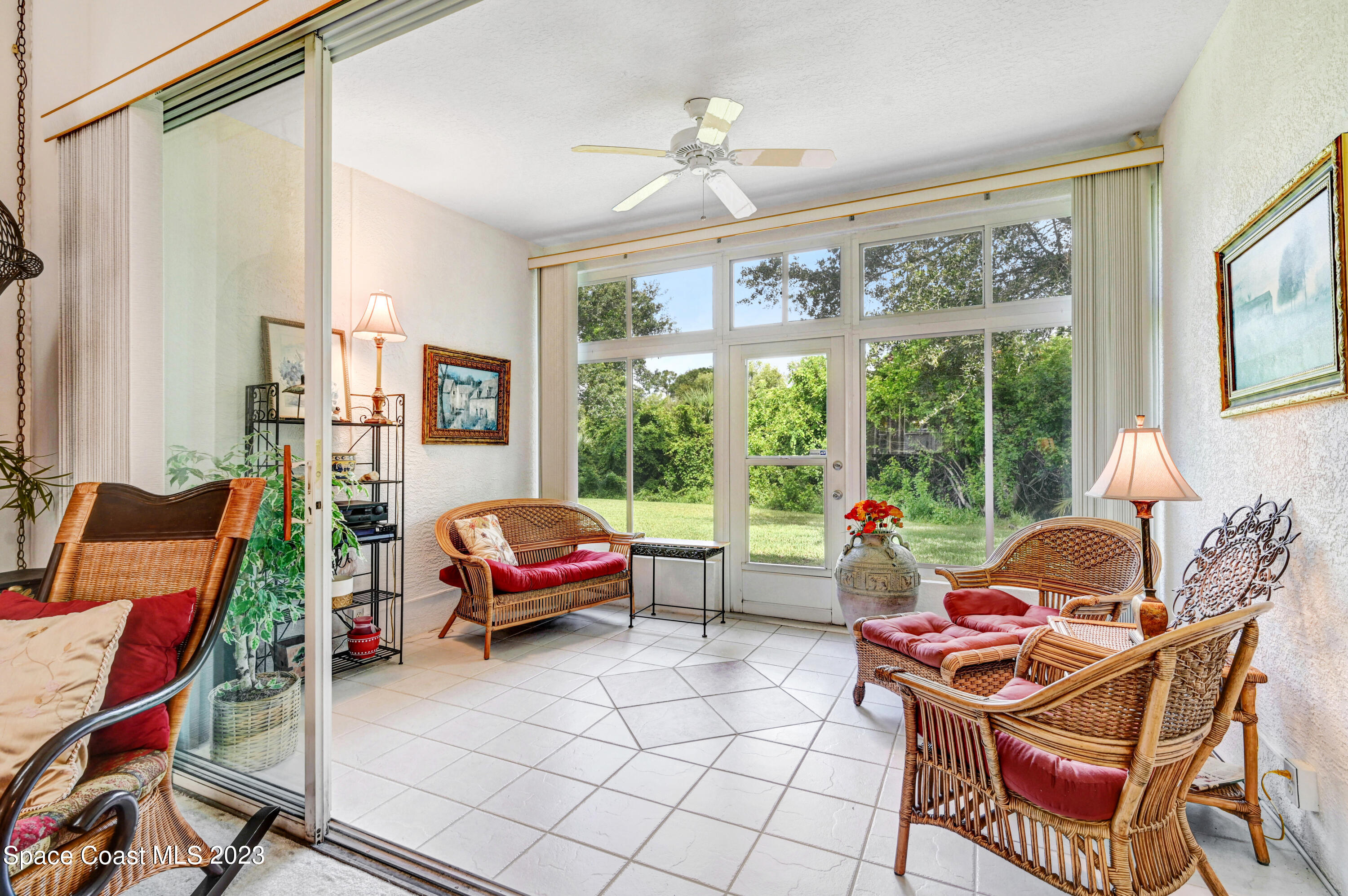 368 Renaissance Avenue Melbourne, FL 32940 - Photo 22 of 29 a living room with furniture and a floor to ceiling window