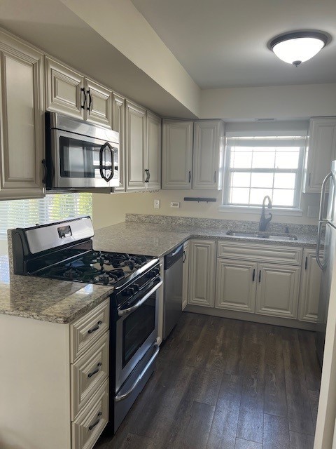 1842 Shetland Road Naperville, IL 60565 - Photo 7 of 30 a kitchen with stainless steel appliances granite countertop a stove and a sink