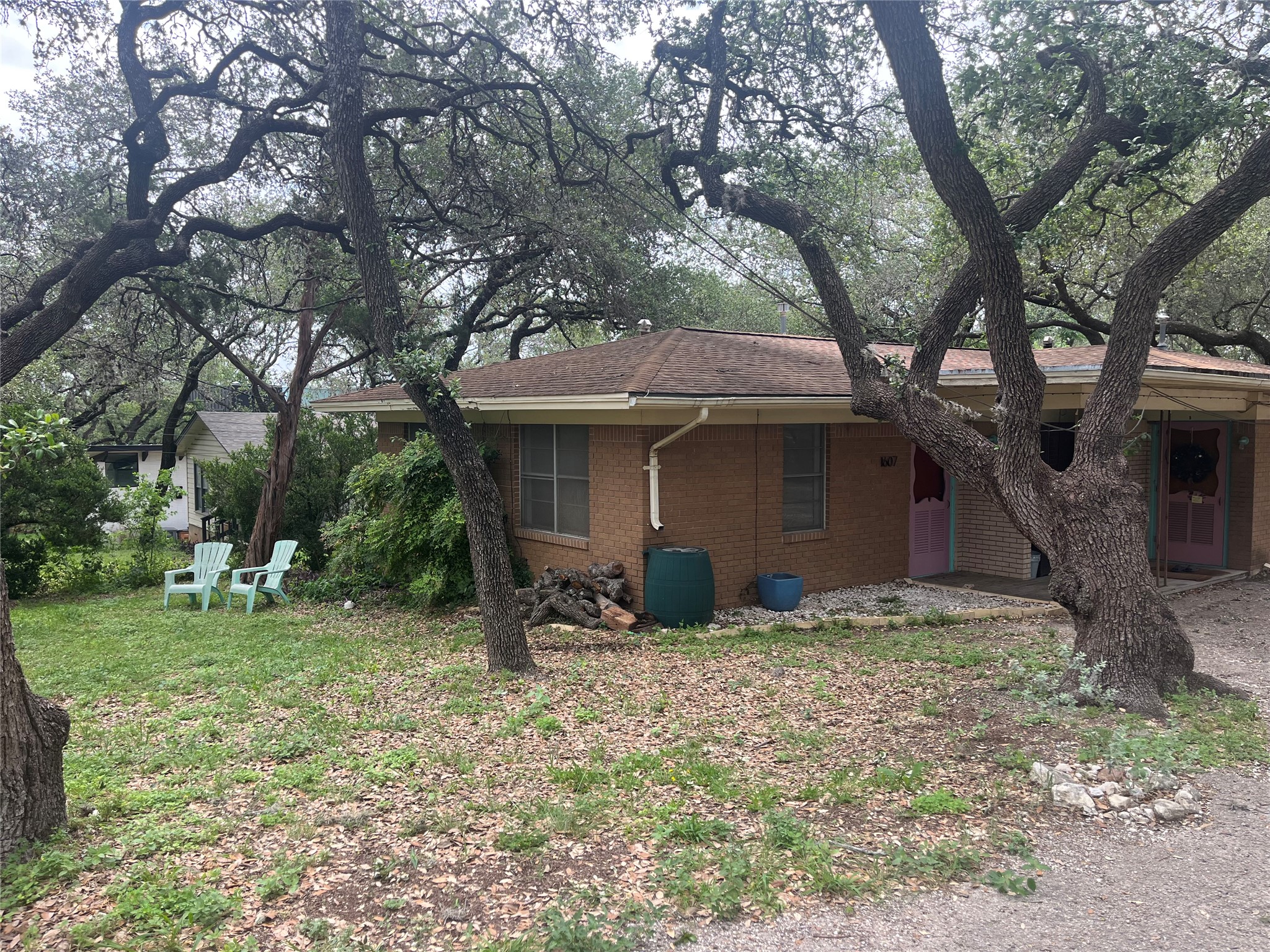 1607 Lightsey Road, Unit A Austin, TX 78704 - Photo 2 of 17 Brick exterior with a brown shingle roof