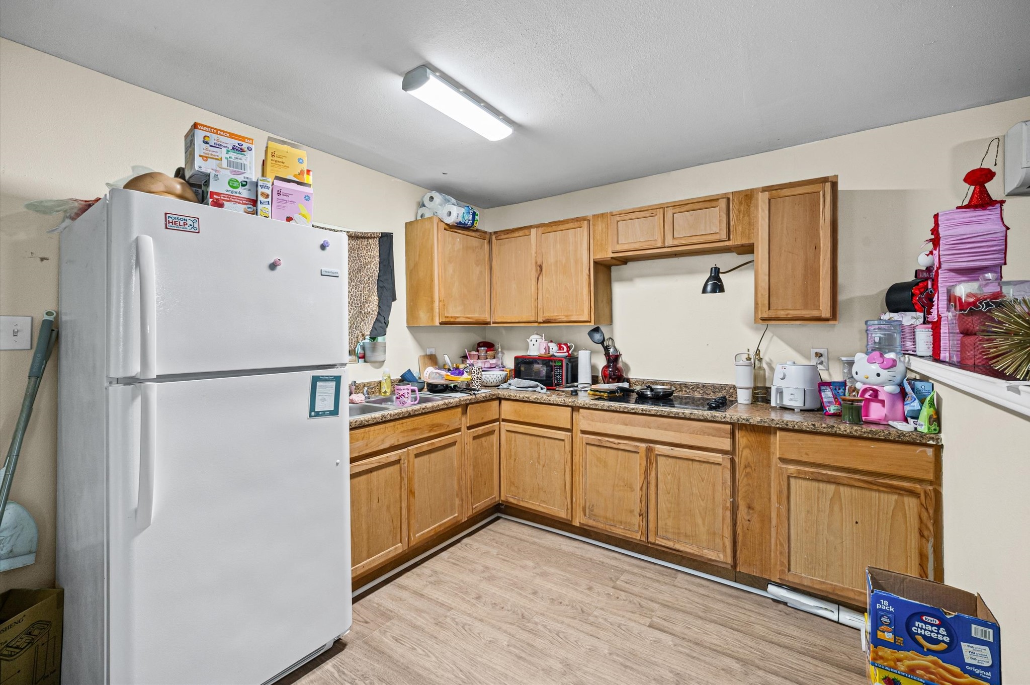 10621 Lane Street Houston, TX 77029 - Photo 24 of 29 a kitchen with stainless steel appliances a refrigerator sink and wooden cabinets