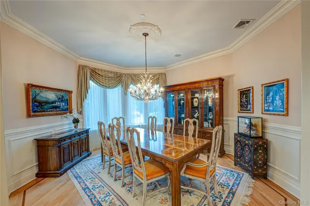 a view of a dining room with furniture and chandelier