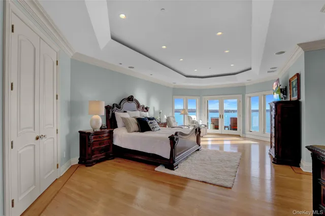 a spacious bedroom with a bed and a large window