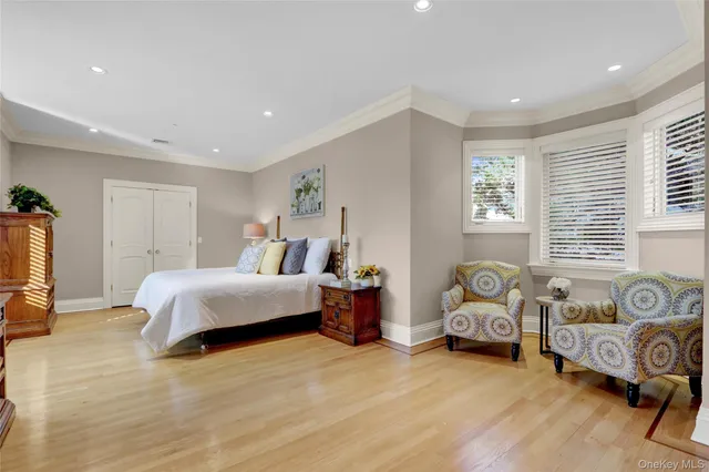 a spacious bedroom with a bed and a couch