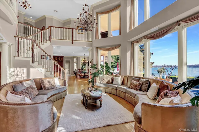 a living room with furniture fireplace and a large window