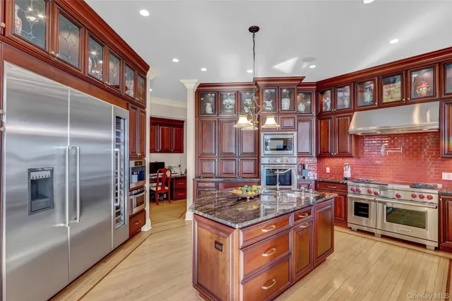 a kitchen with stainless steel appliances granite countertop a stove and a refrigerator
