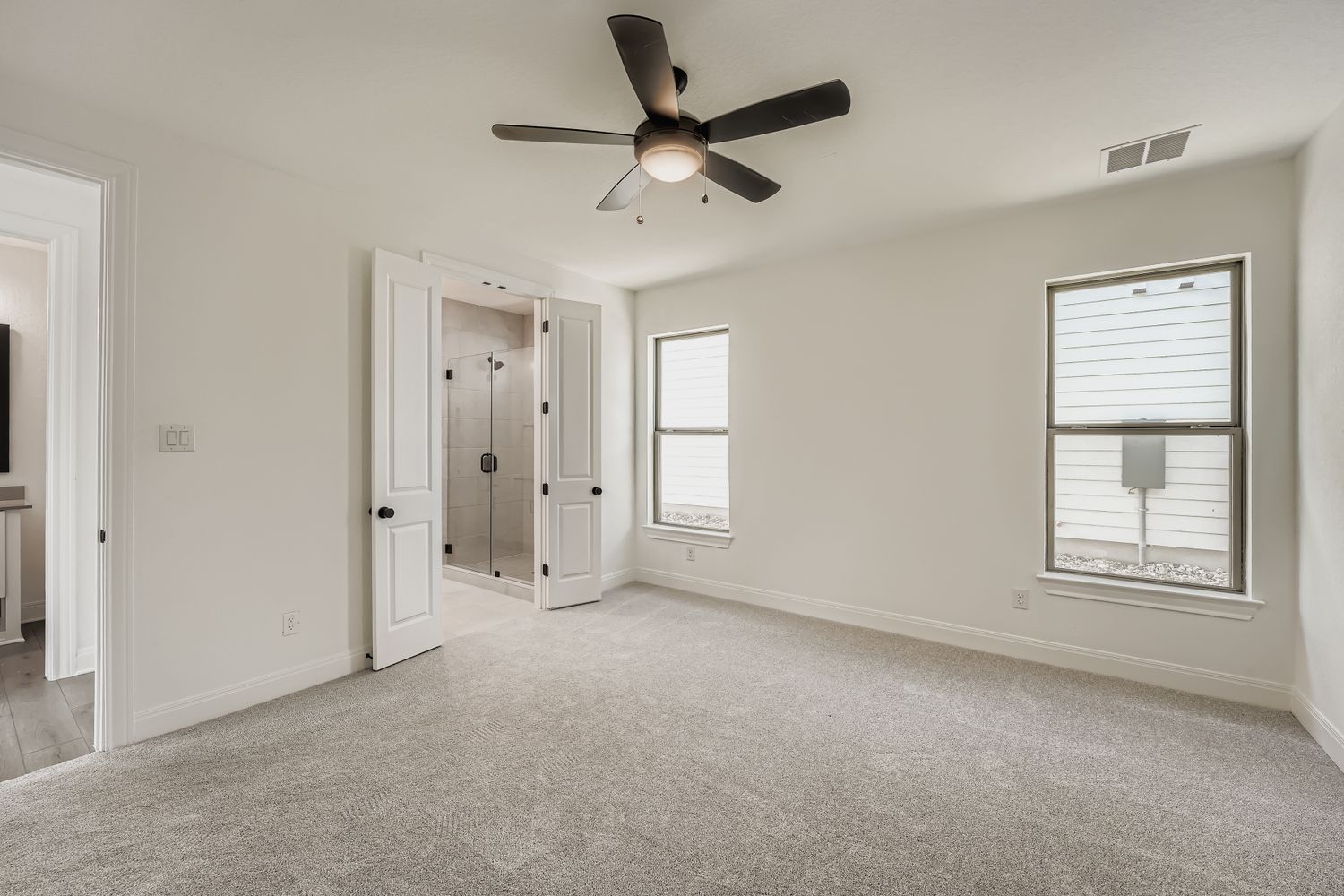 376 Orleanian Drive Buda, TX 78610 - Photo 6 of 10 an empty room with chandelier fan and windows