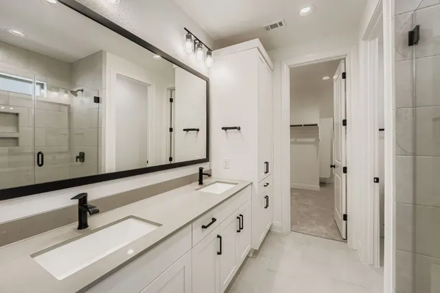 a bathroom with a double vanity sink and mirror