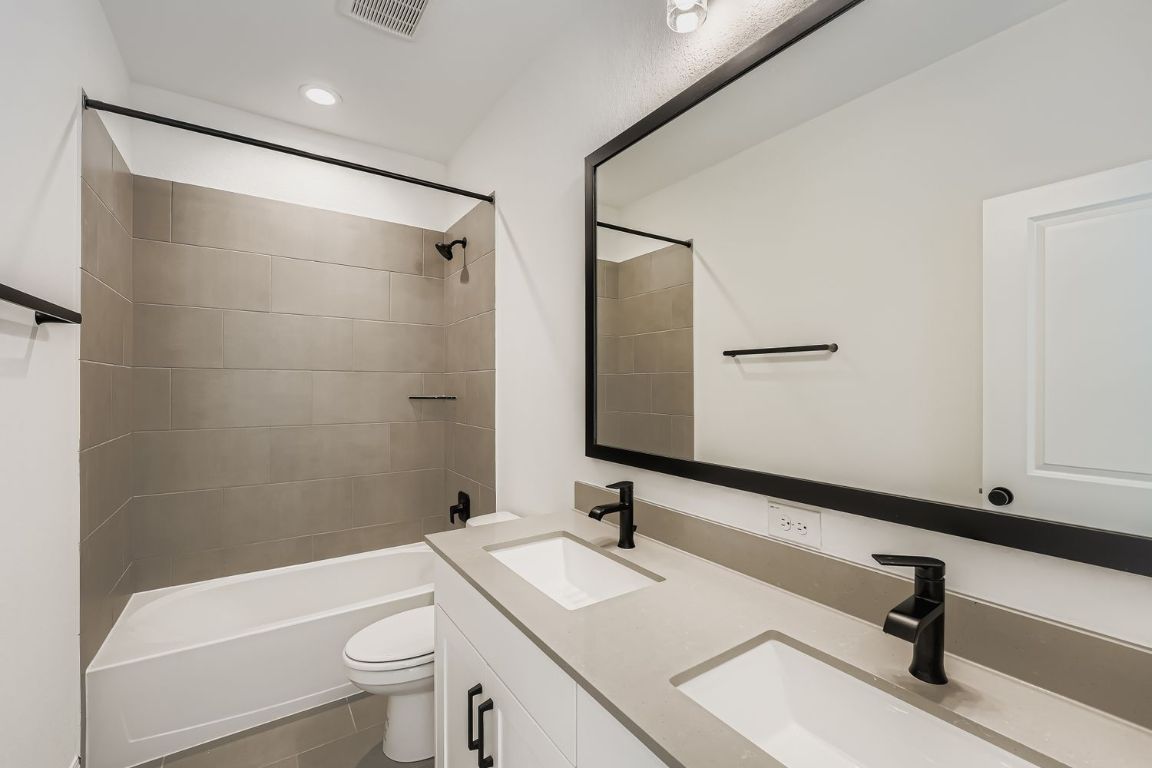 376 Orleanian Drive Buda, TX 78610 - Photo 9 of 10 a bathroom with a sink toilet a mirror and shower