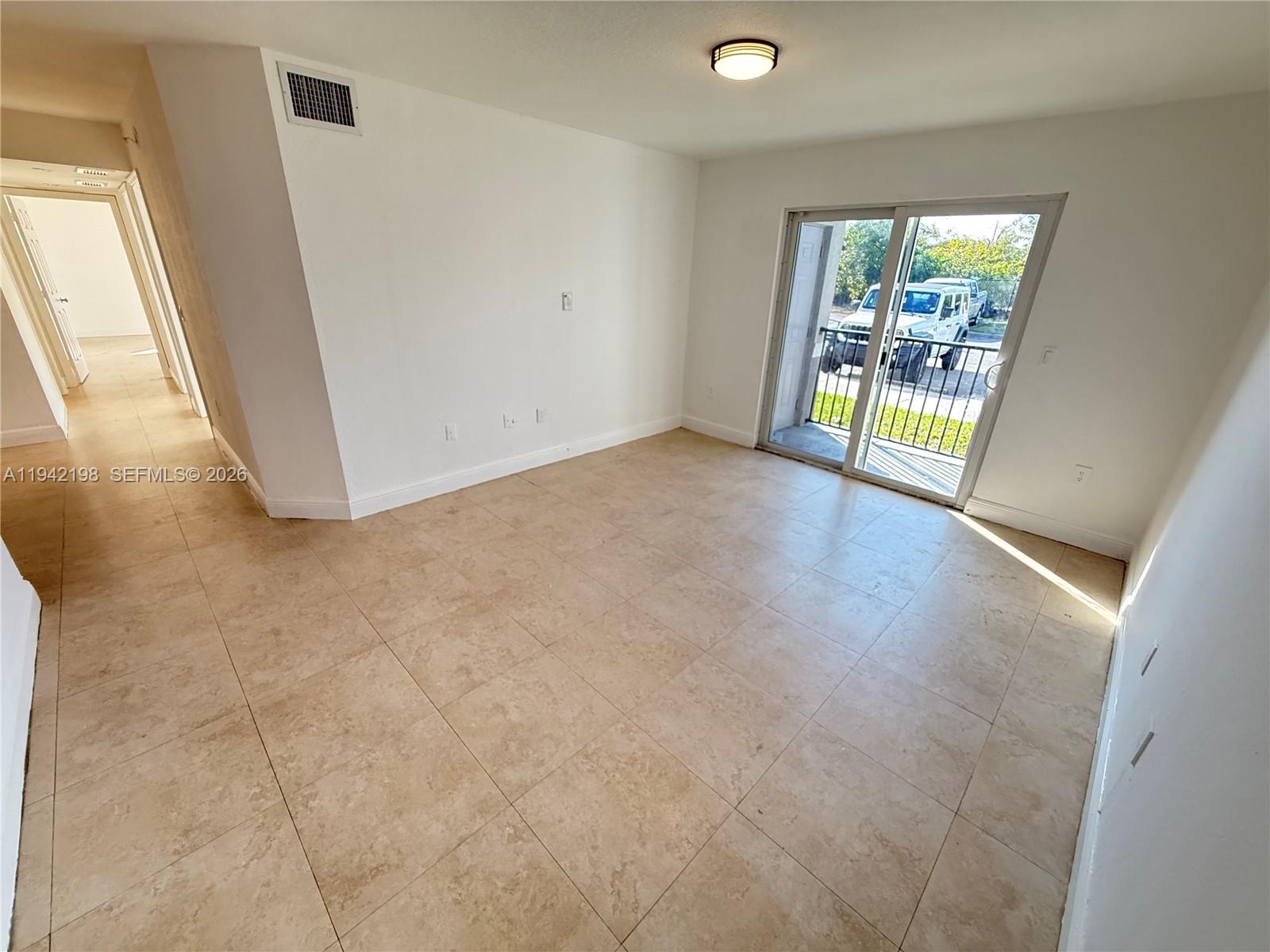 15460 Southwest 284th Street, Unit 4102 Homestead, FL 33033 - Photo 1 of 19 an empty room with windows