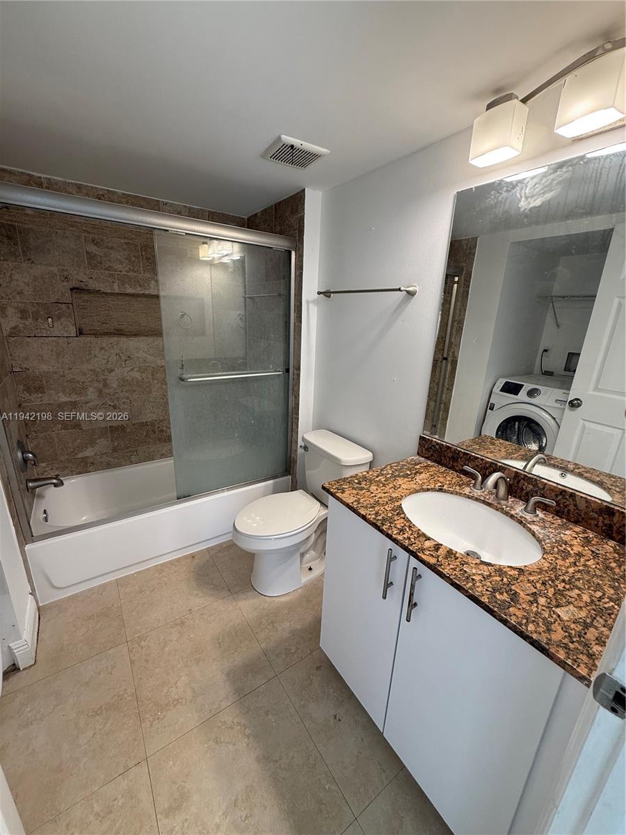 15460 Southwest 284th Street, Unit 4102 Homestead, FL 33033 - Photo 14 of 19 a bathroom with a granite countertop sink a toilet and shower