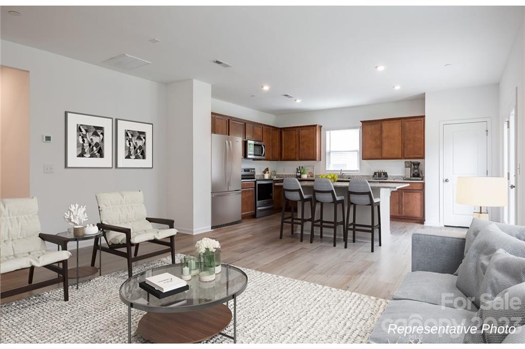 1244 Maple Shade Road Southwest, Unit 73 Concord, NC 28027 - Photo 3 of 12 a living room with furniture kitchen view and a window