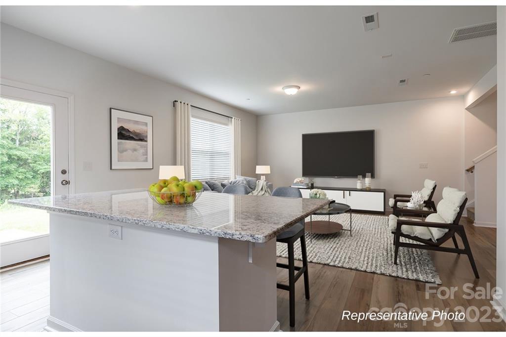 1244 Maple Shade Road Southwest, Unit 73 Concord, NC 28027 - Photo 5 of 12 a view of a dining room with furniture