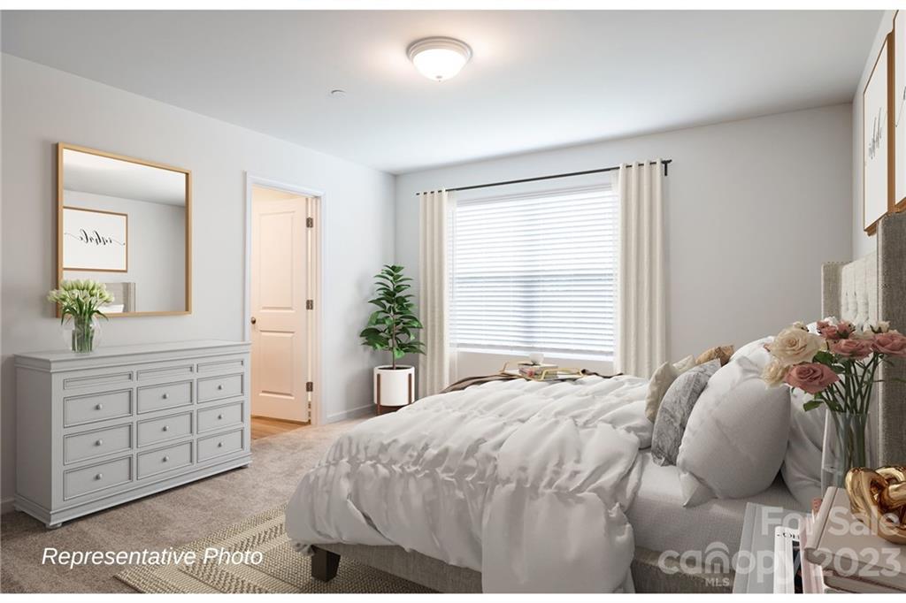 1244 Maple Shade Road Southwest, Unit 73 Concord, NC 28027 - Photo 6 of 12 a bedroom with a bed and a dresser
